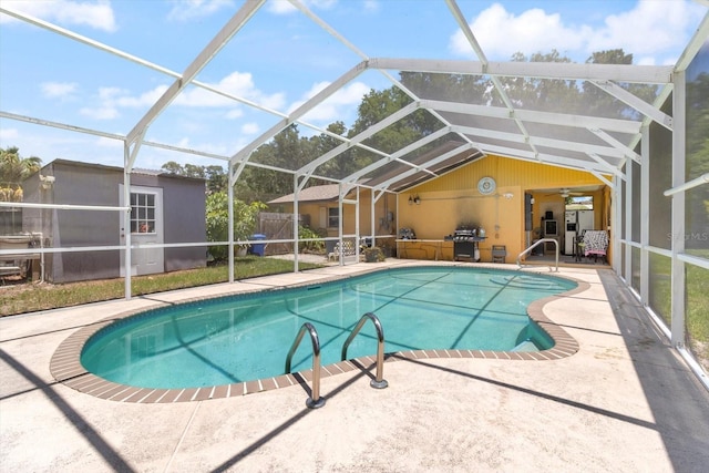 view of swimming pool featuring an outdoor structure, area for grilling, a lanai, and a patio