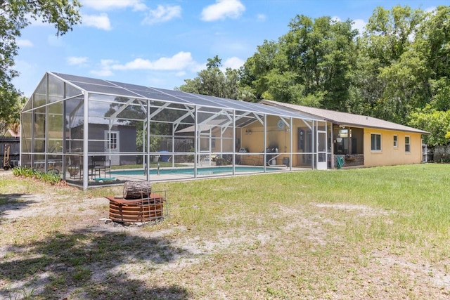 back of property with a lanai and a yard