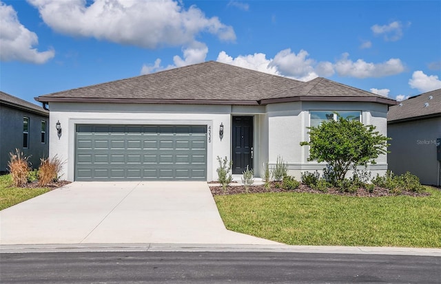 ranch-style home with a garage and a front lawn