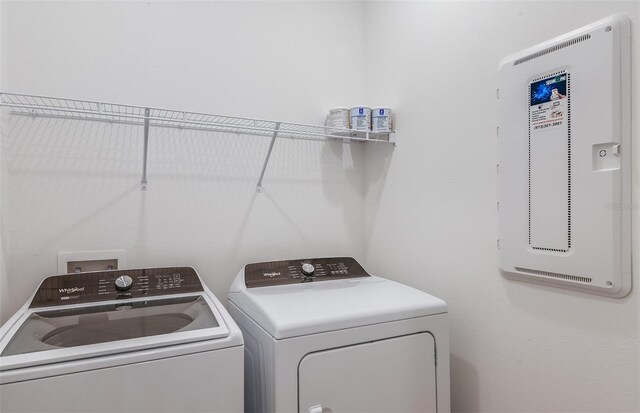 clothes washing area with washing machine and clothes dryer