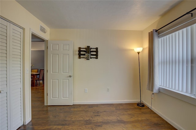 empty room featuring dark hardwood / wood-style flooring