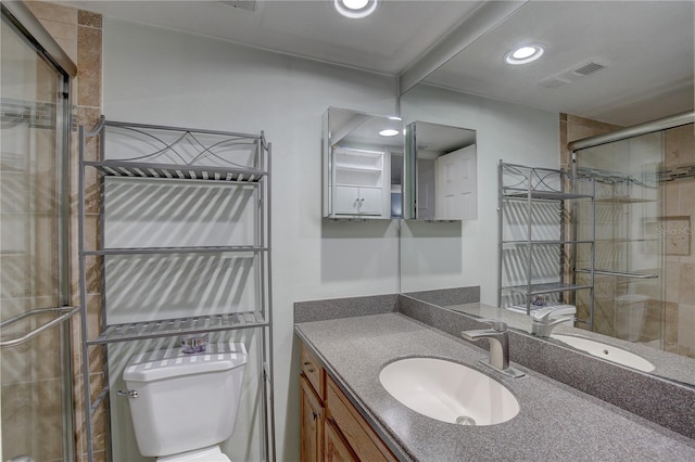 bathroom featuring vanity, toilet, and walk in shower