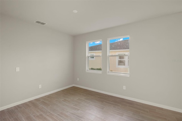 spare room with light wood-type flooring