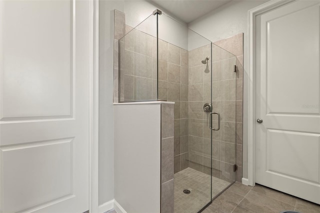 bathroom with tile patterned flooring and walk in shower