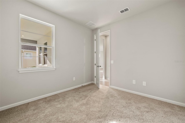 empty room with light colored carpet