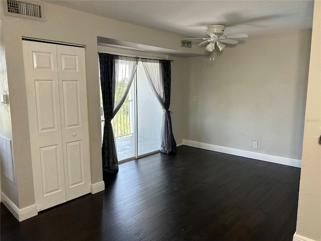 spare room with ceiling fan and dark hardwood / wood-style flooring