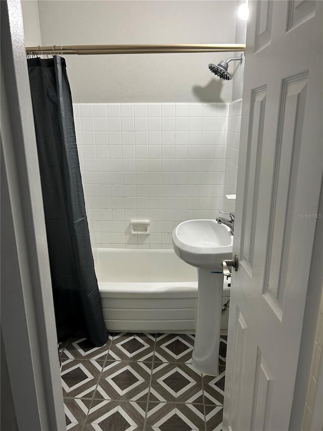 bathroom featuring tile patterned flooring and shower / tub combo