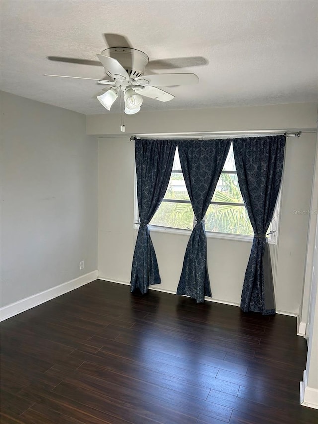 unfurnished room with a textured ceiling, dark hardwood / wood-style floors, and ceiling fan