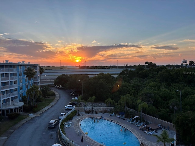 view of pool at dusk