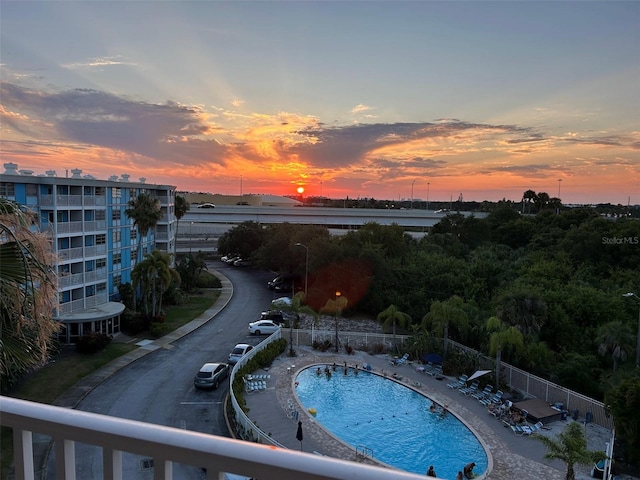 view of pool at dusk