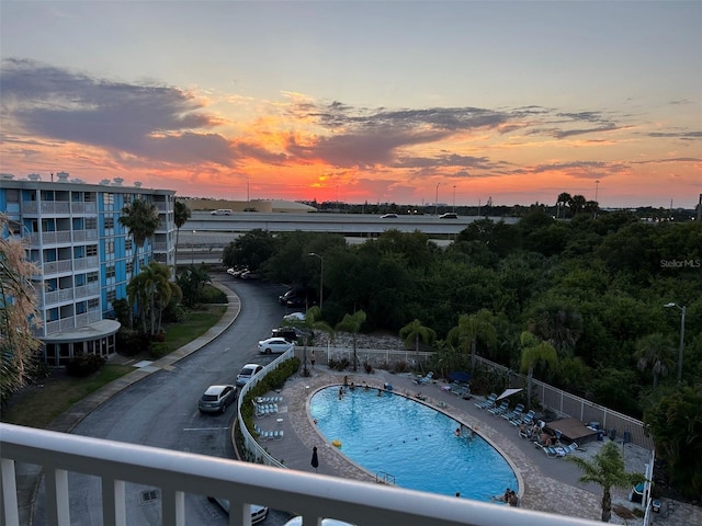 view of pool at dusk