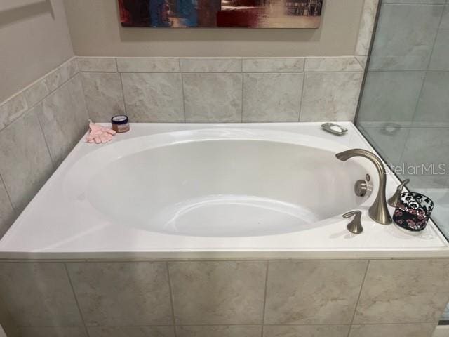 bathroom with tiled tub