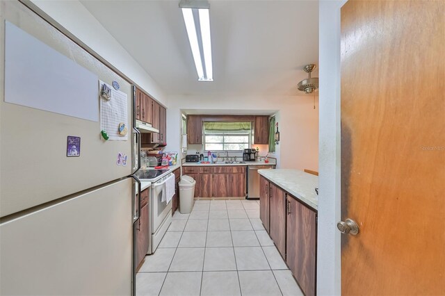 kitchen with white appliances and light tile patterned floors