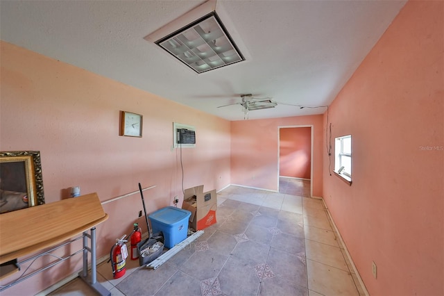 miscellaneous room with ceiling fan and tile patterned floors