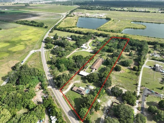 birds eye view of property with a water view and a rural view