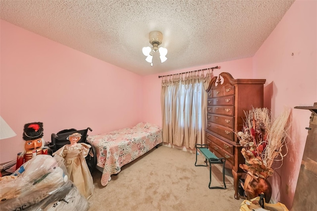 bedroom featuring light colored carpet and a textured ceiling