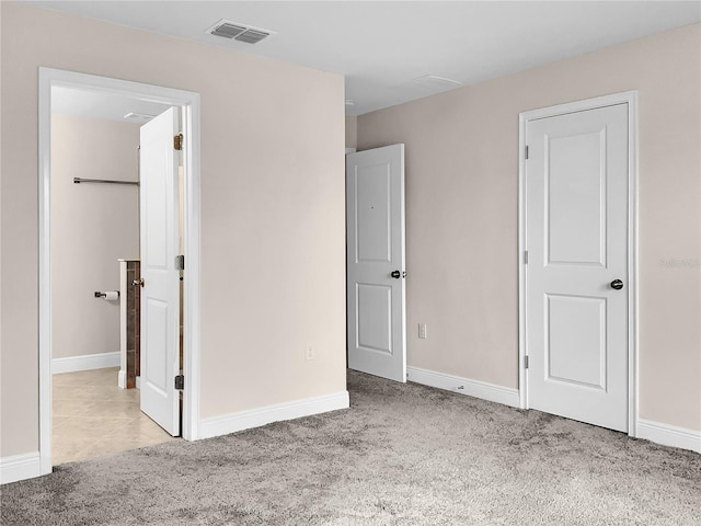 unfurnished bedroom featuring light carpet