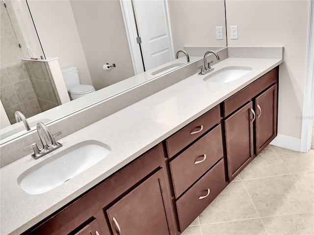 bathroom with vanity, toilet, and tile patterned floors