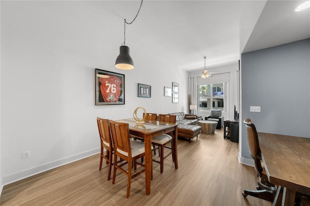 dining space featuring ceiling fan and light hardwood / wood-style flooring