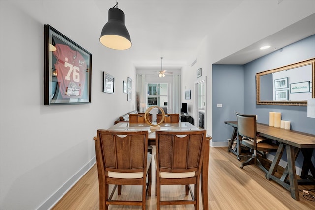 dining space with ceiling fan and light hardwood / wood-style flooring