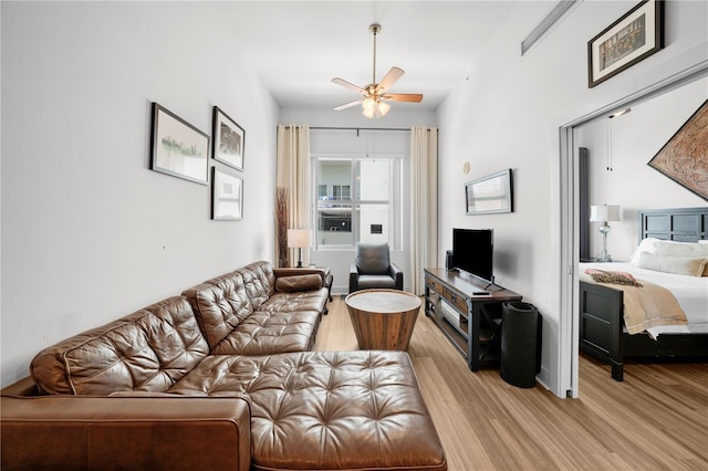 living room featuring ceiling fan and light wood-type flooring