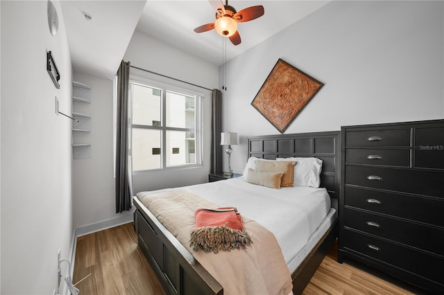 bedroom with ceiling fan and light hardwood / wood-style flooring