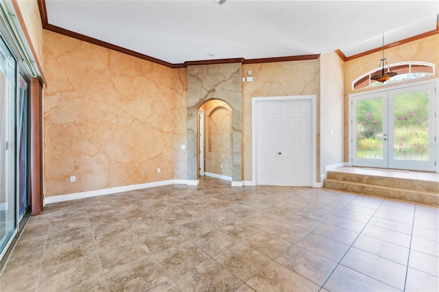 tiled empty room with french doors and ornamental molding