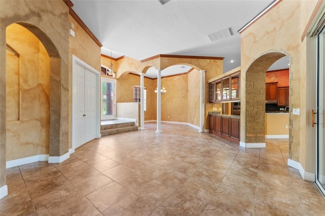 interior space featuring a textured ceiling, crown molding, and tile patterned flooring