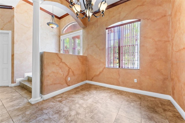 tiled empty room featuring a notable chandelier, ornamental molding, and ornate columns