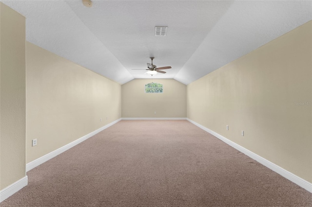 bonus room with ceiling fan, carpet floors, and vaulted ceiling