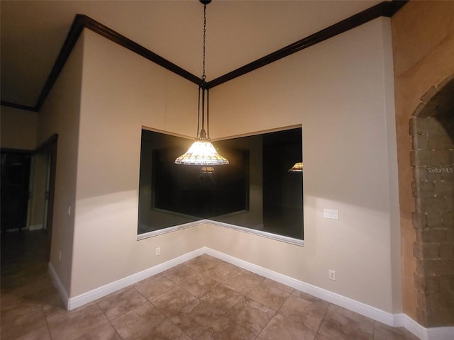 unfurnished dining area with ornamental molding and tile patterned floors