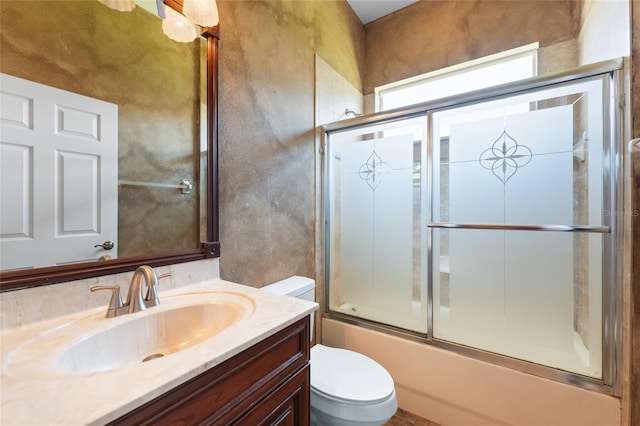 full bathroom featuring shower / bath combination with glass door, toilet, and vanity