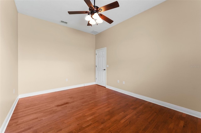 empty room with ceiling fan and hardwood / wood-style floors