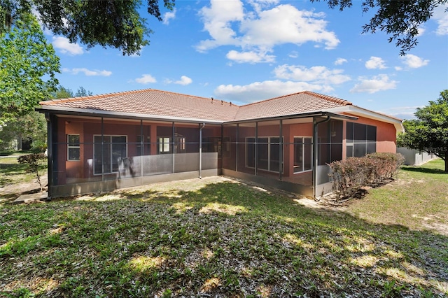 back of house with a sunroom and a yard