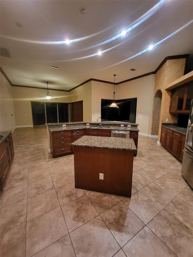 kitchen with a center island, arched walkways, crown molding, a sink, and a peninsula