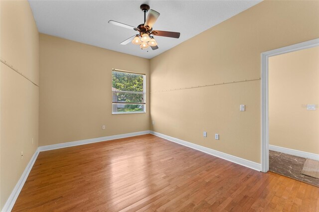 spare room with ceiling fan, baseboards, and wood finished floors