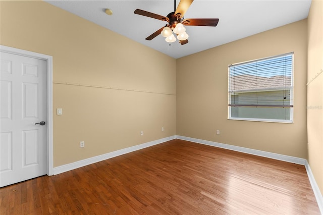 unfurnished room featuring a ceiling fan, baseboards, and wood finished floors