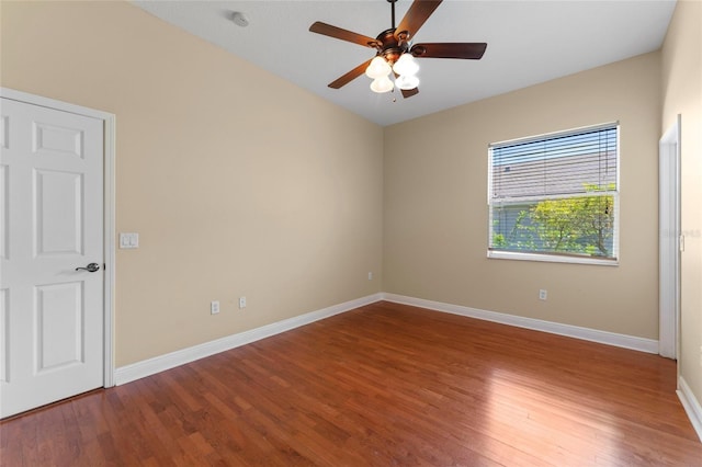 unfurnished room with a ceiling fan, baseboards, and wood finished floors