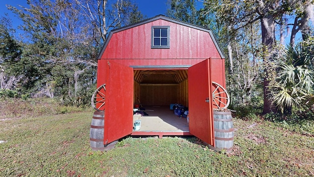 view of outdoor structure featuring a lawn