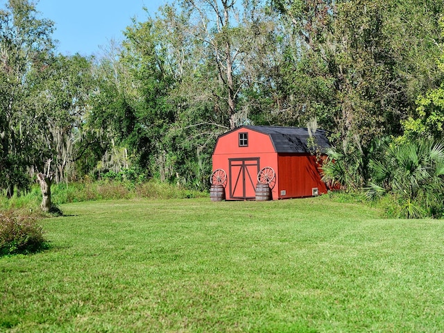 view of outbuilding with a yard