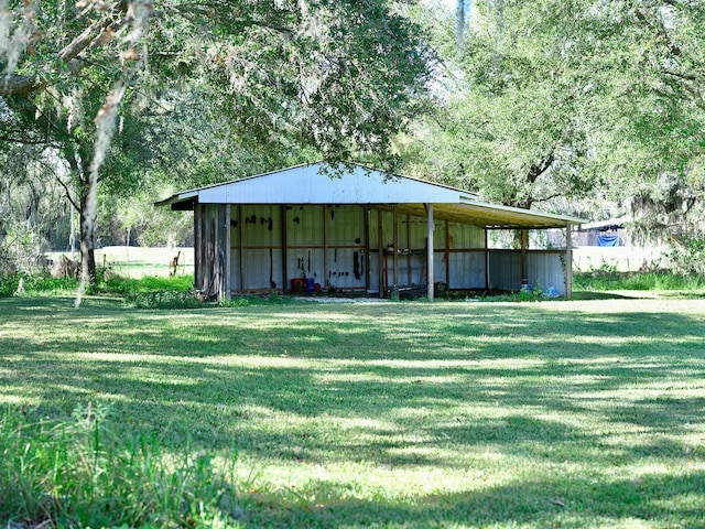 view of outbuilding with a yard