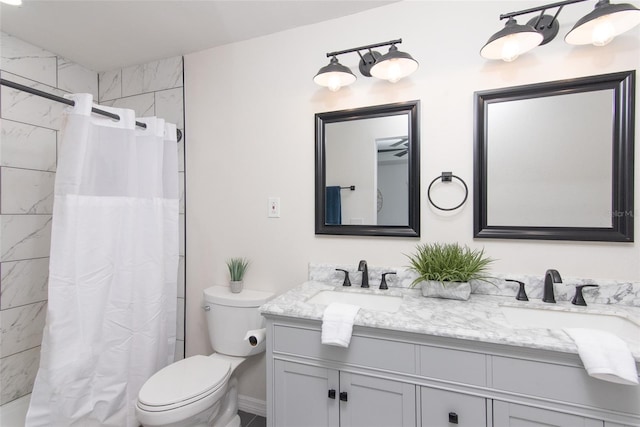 bathroom featuring vanity, curtained shower, and toilet