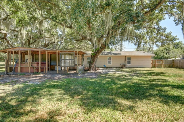 rear view of house featuring a lawn