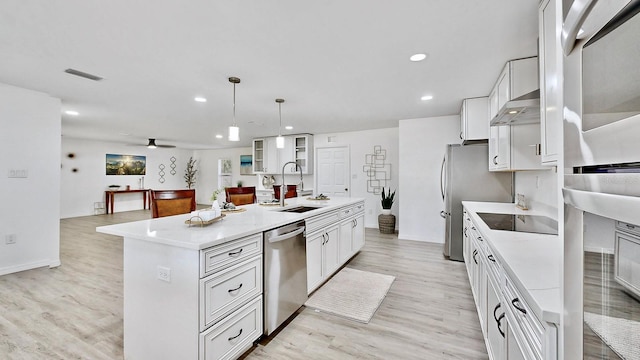 kitchen with white cabinetry, pendant lighting, a center island with sink, appliances with stainless steel finishes, and light wood-type flooring