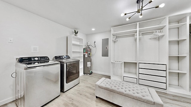 laundry area featuring separate washer and dryer, electric water heater, light hardwood / wood-style flooring, electric panel, and a chandelier