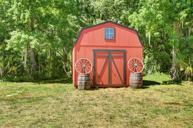 view of outbuilding featuring a yard