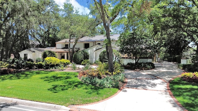 mediterranean / spanish house featuring a front yard