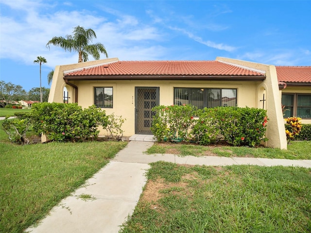 mediterranean / spanish-style house with a front yard