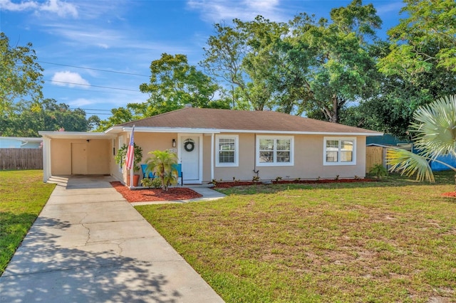 view of front of property featuring a front lawn and a carport