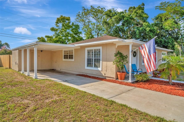 view of front of house with a carport and a front yard